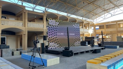 The stage area is decked with cinderblocks and stacked panels that serve as seating areas. The materials will be resold to suppliers after the triennial concludes in March