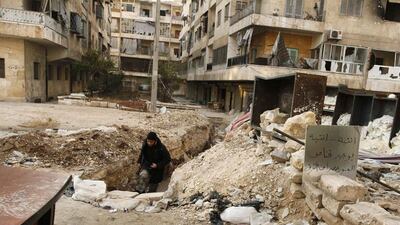 A Syrian rebel runs through a trench in Aleppo's Bustan Al Qasr neighbourhood to avoid snipers, as the conflict continues. Peace talks scheduled next month have raised hopes that a solution can be found "for the silent majority" of Syrians. Molhem Baraket / Reuters