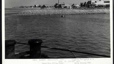 View of Dubai Creek with a traditional house with wind tower on right. Courtesy Arabian Gulf Digital Archive