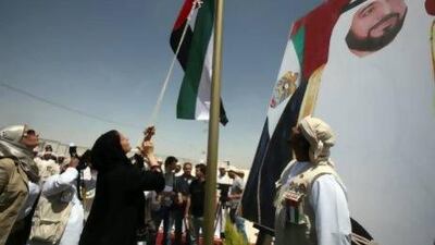 Sheikha Lubna Al Qasimi raises the Emirati flag to inaugurate the Emirati-Jordanian camp for Syrian refugees in the Mreijeb al Fhoud area of in east Jordan yesterday. Salah Malkawi for The National