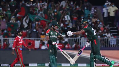 Bangladesh's Afif Hossain, left, with teammate Mohammad Naim during the Twenty20 World Cup first round match against Oman in Muscat. AP