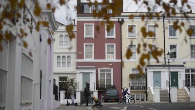 A pedestrian walks past residential houses in Notting Hill in London. UK lenders approved 104,969 mortgages in November – the highest level since the financial crisis. Bloomberg