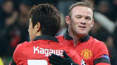 Wayne Rooney and Shinji Kagawa celebrate during United's 5-0 win over Leverkusen on Wednesday night. Federico Gambarini / EPA
