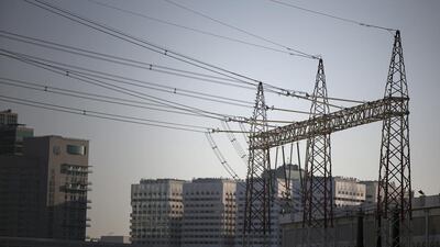 Electrical towers that feed Abu Dhabi are pictured near Al Maryah Island. Silvia Razgova / The National