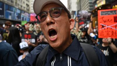 A man shouts slogans as he joins thousands of protesters in a new rally against a controversial extradition law proposal in Hong Kong. AFP
