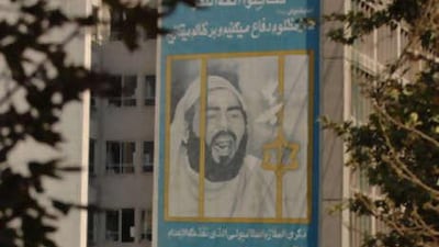 A mural of Khaled el Islambouli, the assassin of Anwar Sadat, hangs over a building in Iran.