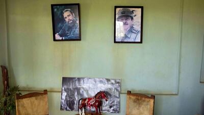 Portraits of Cuba’s president Raul Castro, right, and Fidel Castro hang on the wall above a statue of a horse at the state-run Azucarero horse ranch in Artemisa, Cuba. Cuba’s tradition of horse breeding and training dates to the 16th century but after the 1959 communist revolution, Fidel Castro’s government banned horse racing along with gambling and professional sports. Ramon Espinosa / AP Photo