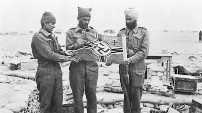 Indian troops with a Nazi flag in the rubble of Western Desert trenches, Libya, in May 1942 after the capture of Omar Al Mukhtar, the resistance leader against the Italian occupation. Up to 2.5 million Indians fought for Britain during the Second World War. Bettmann / Corbis / Getty Images.
