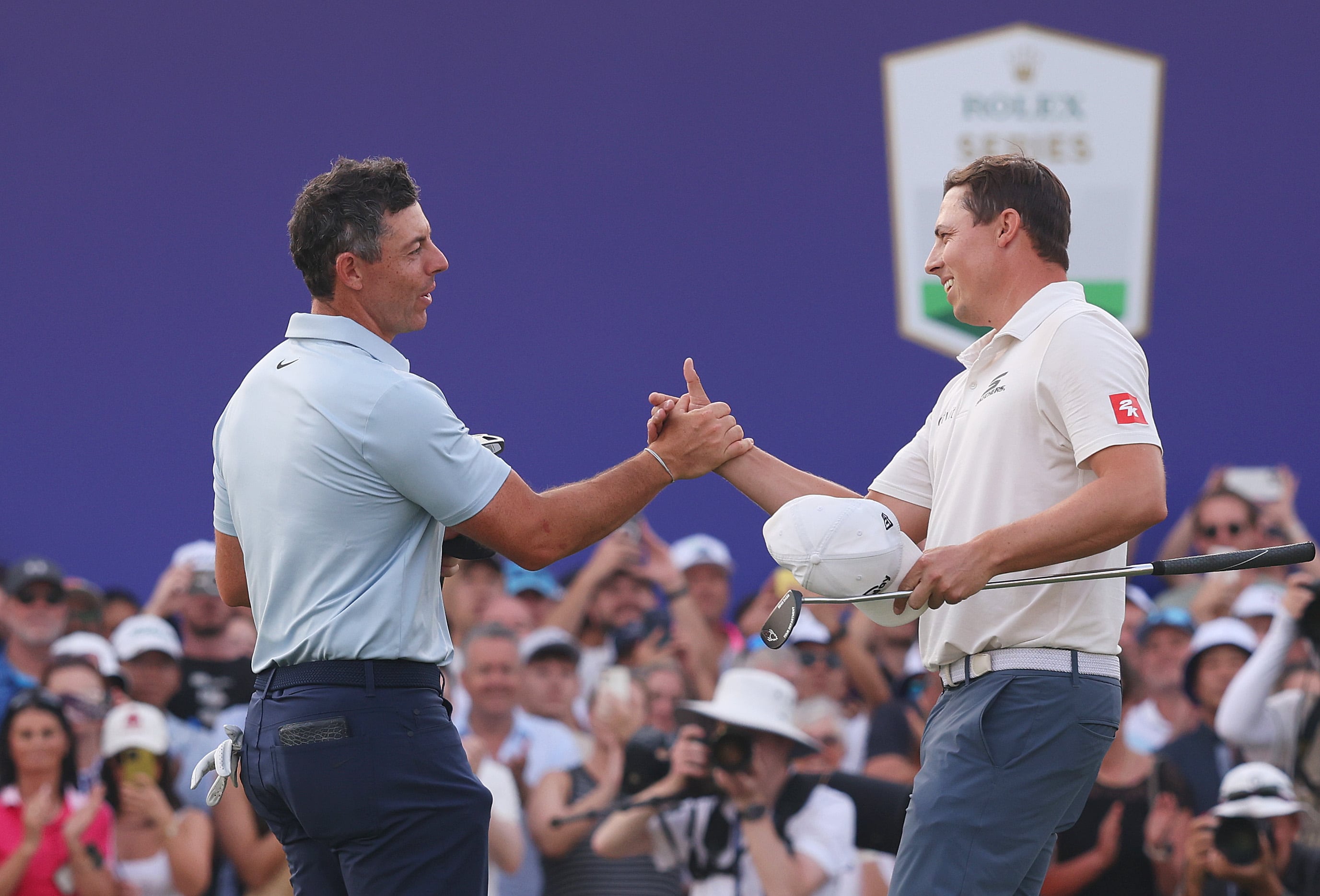 Matt Fitzpatrick, right, and Rory McIlroy shake hands on the 18th green after the Englishman won a play-off to secure the DP World Tour Championship title at Jumeirah Golf Estates. Getty Images
