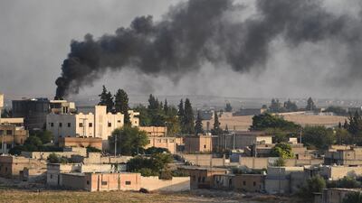 A Turkish army armoured vehicle advances in the Syrian city of Tel Abyad, as seen from the Turkish border town of Akcakale, Turkey. Getty Images