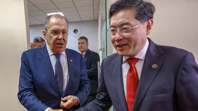Russian Foreign Minister Sergey Lavrov shakes hands with his Chinese counterpart Qin Gang. EPA