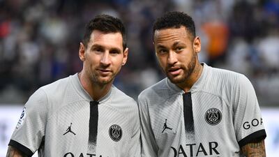 PSG's Neymar chats with teammate Lionel Messi. AFP