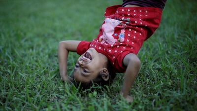 A young migrant plays games as he rests in a makeshift camp in Juan Rodriguez Clara, Mexico. Reuters