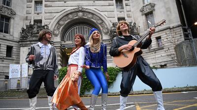 The cast of 'Abba Mania' poses outside Waterloo Station in London. Cast members are getting ready to return to the stage on May 21, as Covid-19 restrictions are eased. EPA