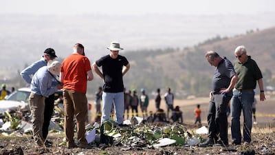Investigators with the NTSB look over debris at the crash site. Getty Images