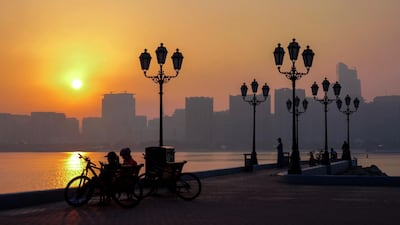 The sun rises on a foggy Wednesday morning at the Corniche. Victor Besa / The National