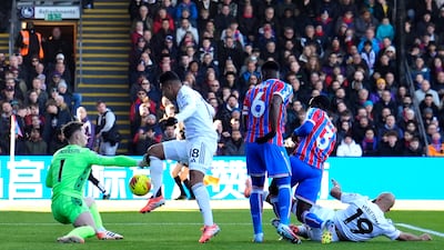 Crystal Palace goalkeeper Dean Henderson saves from United's Casemiro in the first minute of the match. PA