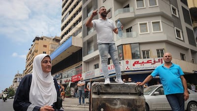 A demonstrator shouts slogans from a road block during an anti-government protest in Beirut, Lebanon. Bloomberg