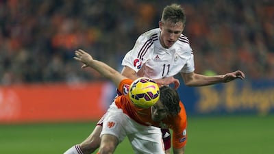 Latvia's Valerijs Sabala, top, fights for the ball with Daley Blind of the Netherlands during their Euro 2016 qualifying match on Sunday. Paul Vreeker / United Photos / Reuters / November 16, 2014
