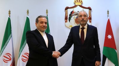 Jordanian Foreign Minister Ayman Al Safadi, right, greets his Iranian counterpart Abbas Araghchi on his arrival in Amman on Wednesday. EPA