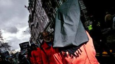 Protesters dressed as Guantanamo Bay prisoners are chained together during the Anti-War march through the streets of Central London in February 2007.