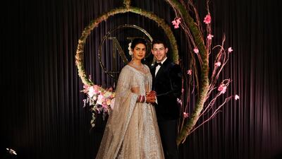 Newlyweds Priyanka Chopra, 36, and Nick Jonas, 26, pose for a photograph during a reception at a hotel in New Delhi on December 4, 2018. Photo: AP