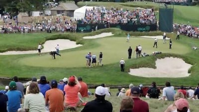 Tiger Woods retrieves his ball as fans crowd the hills at the ninth hole during practice for the US Open at Merion Golf Club, 11 miles west of Philadelphia. Merion will play at 6,996 yards compared to 7,170 at last year’s tournament at The Olympic Club in San Francisco.