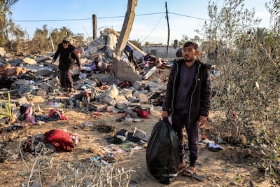 Palestinians inspecting the ruins of a site hit by Israeli strikes east of Khan Younis in the southern Gaza Strip on January 14, 2025. AFP