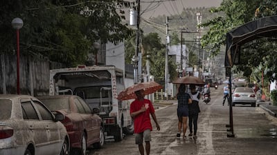 Residents walk along a road covered in ash mixed with rainwater as Taal Volcano erupts on January 12, 2020 in Talisay, Batangas province, Philippines. Getty Images