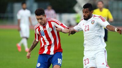Paraguay's striker Tonny Sanabria, left, uses an elbow to fend off the UAE's Mohamed Ahmed during their friendly at Villach, Austria, on September 7, 2014. DANIEL RAUNIG / AFP