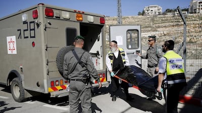 Israeli emergency services remove the body of a Palestinian who was shot dead by Israeli forces at a checkpoint near Jerusalem on February 14, 2016. Amir Cohen / Reuters
