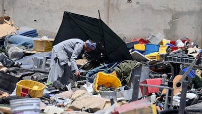 A man selects valuable items at a recycling workshop near the Bagram Air Base. AFP