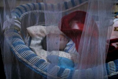 A newborn lies in her crib at the state-run Al Zuhour orphanage, in Mosul, Iraq. The orphanage shelters a mix of infants born to Iraqi women who were enslaved by militants and older children whose parents are jailed; some were simply abandoned in the chaos that follows a war. AP
