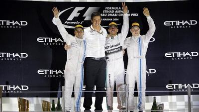 Williams driver Felipe Massa, left, Mercedes head Toto Wolff, Mercedes driver Lewis Hamilton and Williams driver Valtteri Bottas celebrate on the podium of the Abu Dhabi Grand Prix at the Yas Marina circuit in Abu Dhabi on November 23, 2014. REUTERS/Hamad I Mohammed