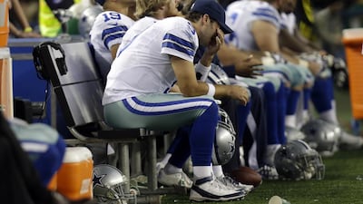 Dallas Cowboys quarterback Tony Romo grimaces in the final minutes of his team's home loss to the Green Bay Packers. Tim Sharp / AP Photo