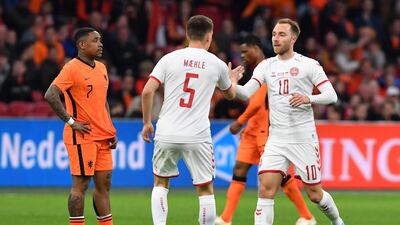 Joakim Maehle congratulates Christian Eriksen following his goal during the match between Netherlands and Denmark. AFP