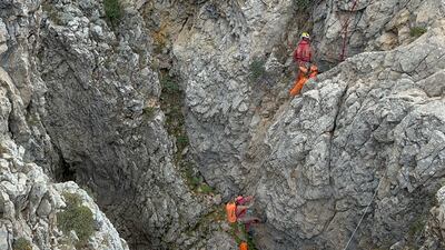 European Cave Rescue Association (ECRA) members work next to the entrance of Morca cave near Anamur, southern Turkey, Thursday, Sept. 7, 2023. Turkish and international cave rescue experts are working to save an American speleologist trapped at a depth of more than 1,000 meters (3,280 feet) in a cave in southern Turkey after he became ill. (Huseyin Yildiz / IHA via AP)