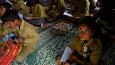 An Indian schoolgirl sits in a classroom at the Chaumuha Primary School on the outskirts of Vrindavan.