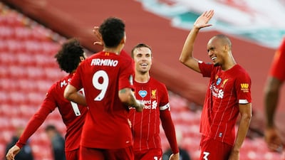 Fabinho celebrates scoring the third goal with teammates. Reuters