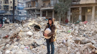 A man stands amid debris as the search for survivors continues in Aleppo after Monday's earthquake. Reuters