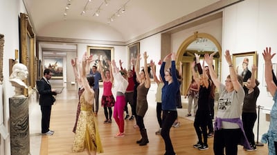 An exercise group works in front of a bust of Benjamin Franklin at the Metropolitan Museum of Art in New York. Mark Lennihan / AP photo