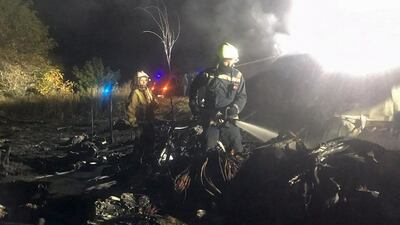 Firefighters work at the crash site of the Antonov AN-26 plane near Chuhuiv. EPA