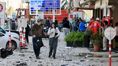 Rescue workers and security officers at the site of an Israeli air strike in the southern coastal city of Sidon, Lebanon. EPA