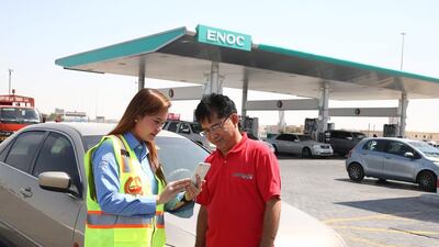 Enoc employees will help drivers register a minor accident by using the Dubai Police smart app. Courtesy ENOC