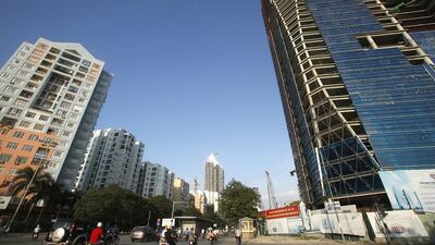 People drive past the new urban area Trung Hoa Nhan Chinh in Hanoi. Kham / Reuters