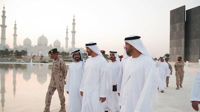 Sheikh Mohammed, speaks with Sheikh Khalifa bin Tahnoon bin Mohammed Al Nahyan (centre L), while visiting the Wahat Al Karama construction site. Seen with Mohammed Al Mazrouei, Undersecretary of the Crown Prince Court of Abu Dhabi (R), Lt Gen Hamad Thani Al Romaithi, Chief of Staff of the Armed Forces (L). Mohamed Al Suwaidi / Crown Prince Court — Abu Dhabi