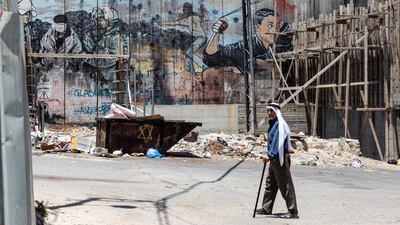 Palestinian Abdel Hadeef Abu Sul, 87, walks along Israel's separation camp near his home/