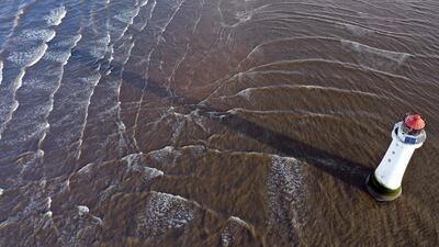The tide moves around the New Brighton lighthouse in north west England. AFP