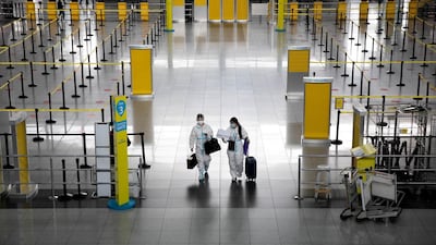 Passengers wearing hazmat suits are seen in Ninoy Aquino International Airport in Paranaque, Metro Manila, Philippines. Reuters