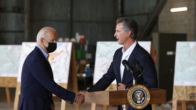 US President Joe Biden shakes hands with California Governor Gavin Newsom after a helicopter tour of the Caldor fire damage in California on September 13, 2021. AFP
